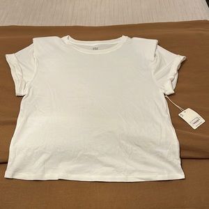 Brand new white top with shoulder pads. Never worn. New with tags. Size large.